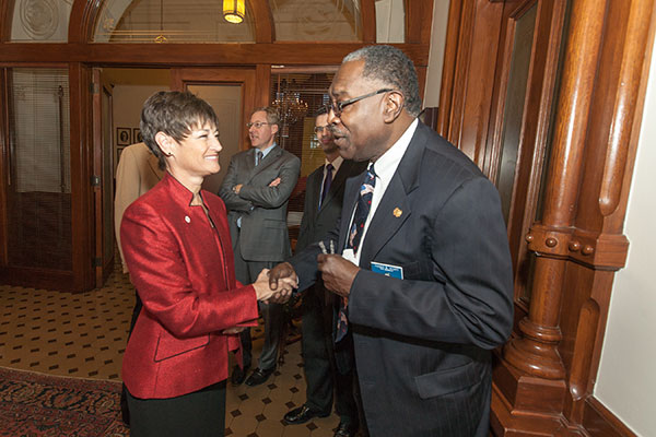 Dr. Campbell shaking hands with a community leader